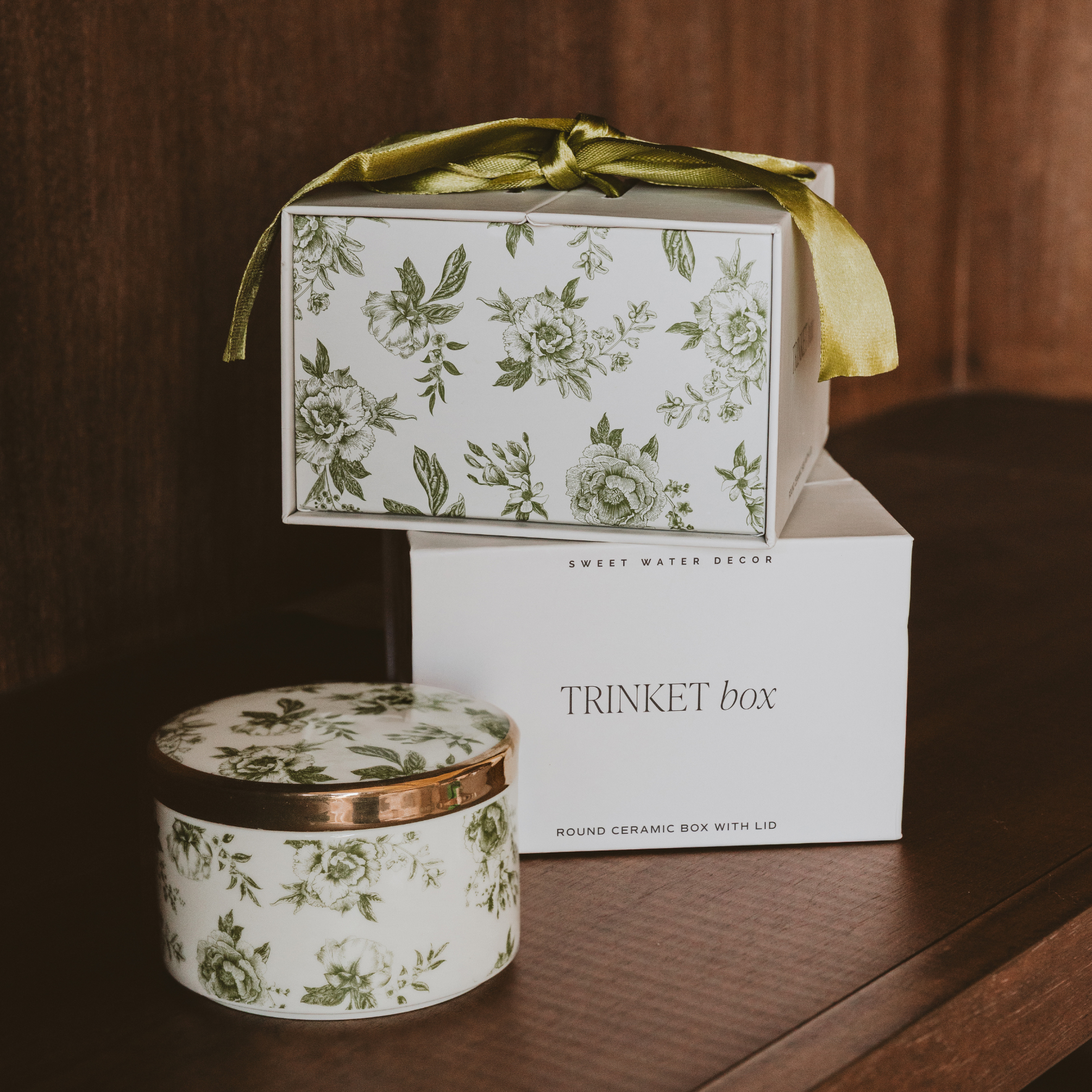 Decorative trinket box with floral design on a wooden surface
